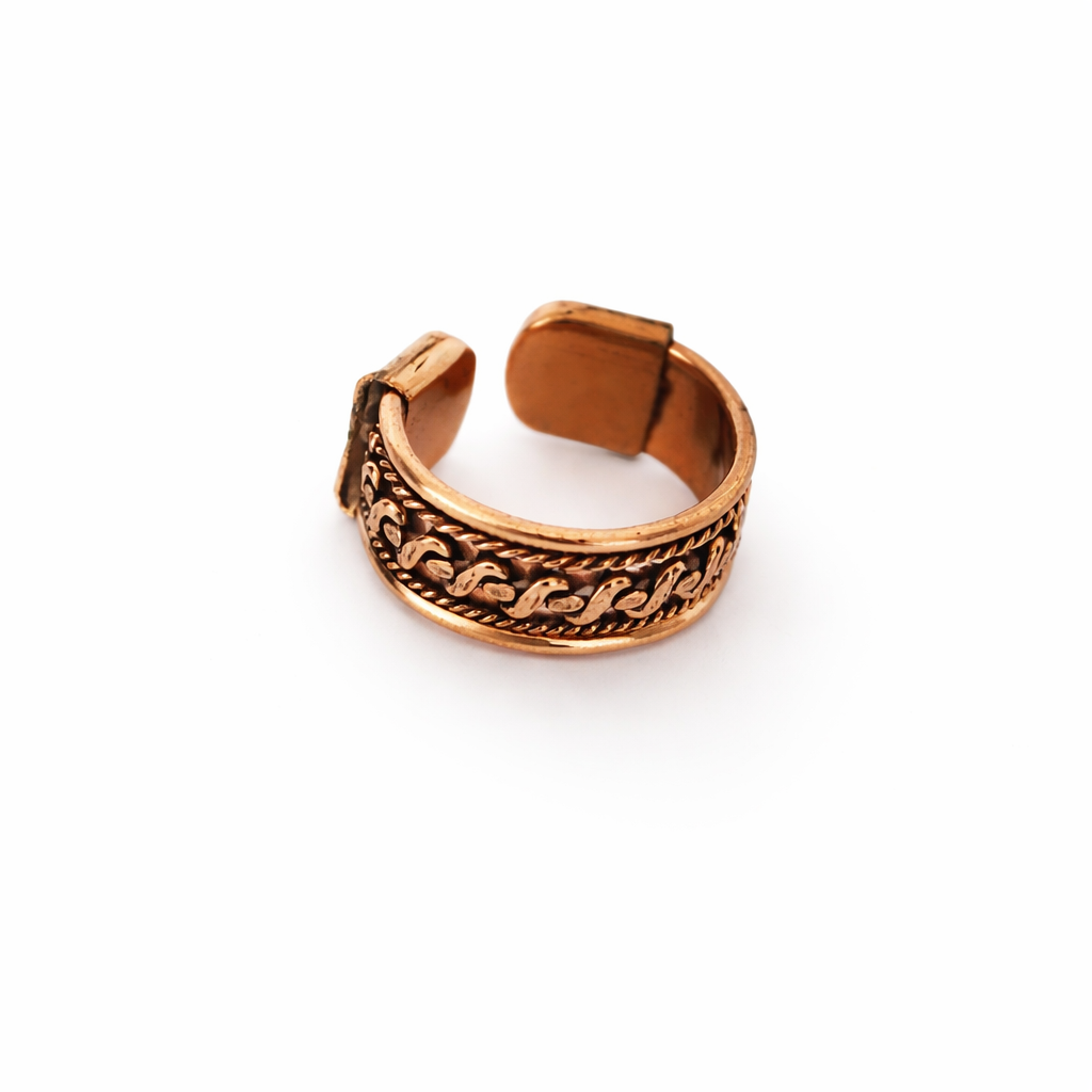 A copper-toned adjustable ring with an ornate, textured pattern on the outer band, shown on a plain white background.
